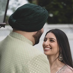 Smiling couple in traditional attire looking at each other during a pre wedding photography session.
