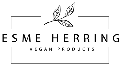 Esme Herring Vegan Products logo with a minimalist leaf branch icon above the brand name, framed by thin corner lines on a transparent background.